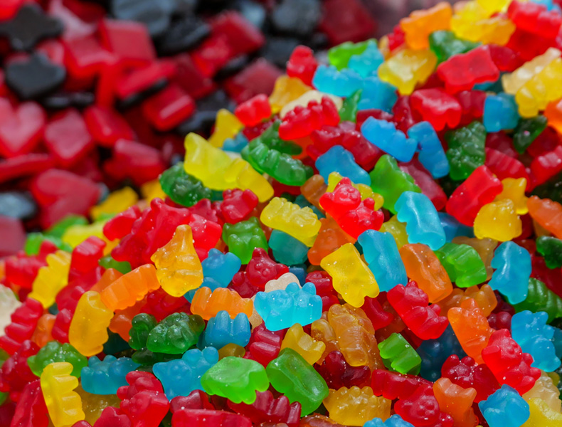 A vibrant pile of colorful gummy bears and candy.