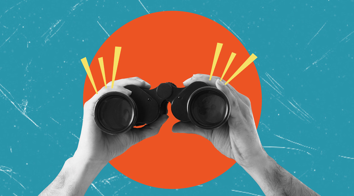 Hands holding binoculars on blue background with orange circle. Concept of analytics and business.