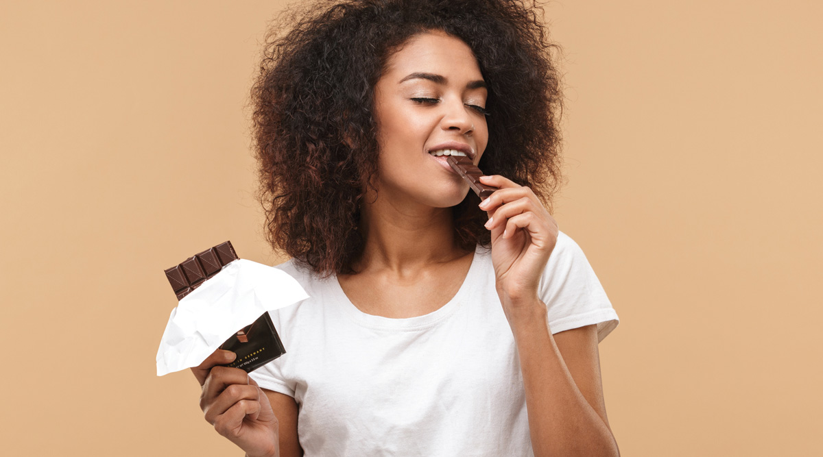 Woman enjoying a chocolate bar