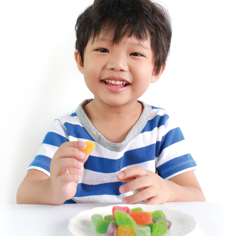 Happy kid eating gummy candy