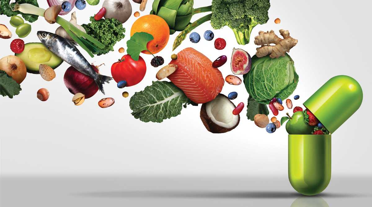 Medicine capsule with fruit vegetables nuts and beans inside as a natural medicine health treatment.