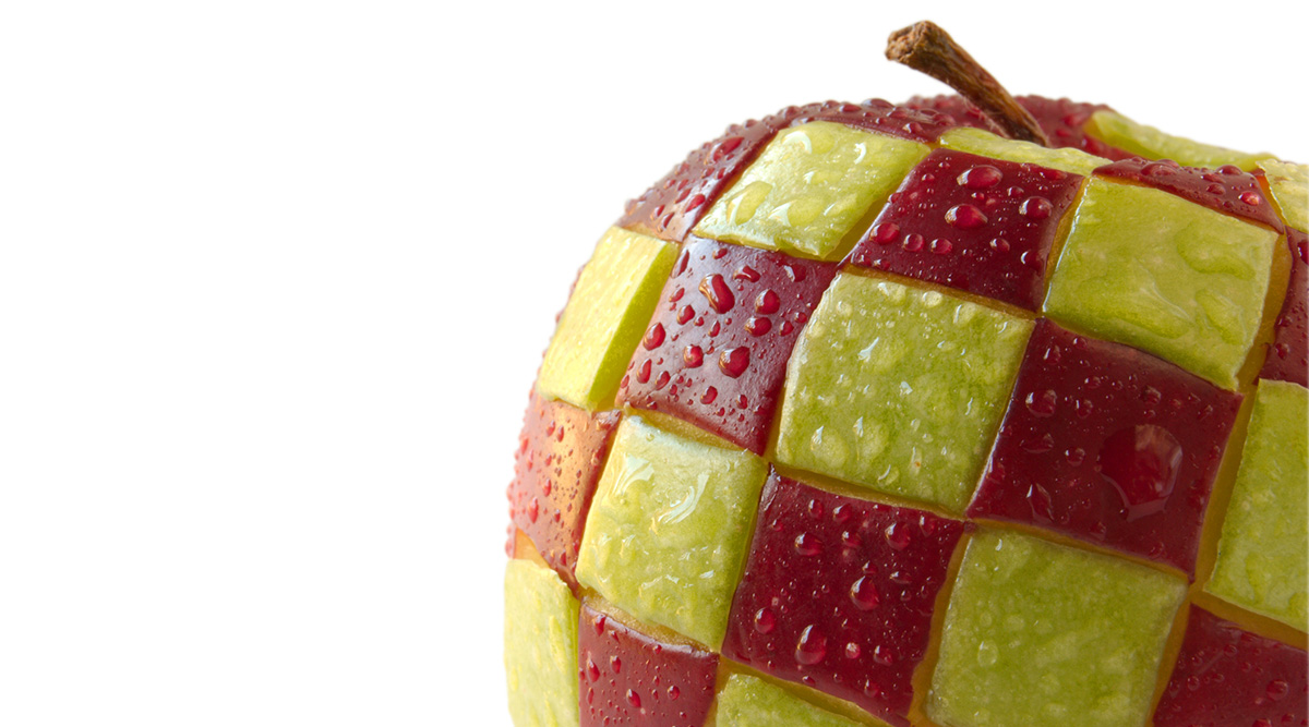 An apple with red and yellow checkered pattern and moist droplets