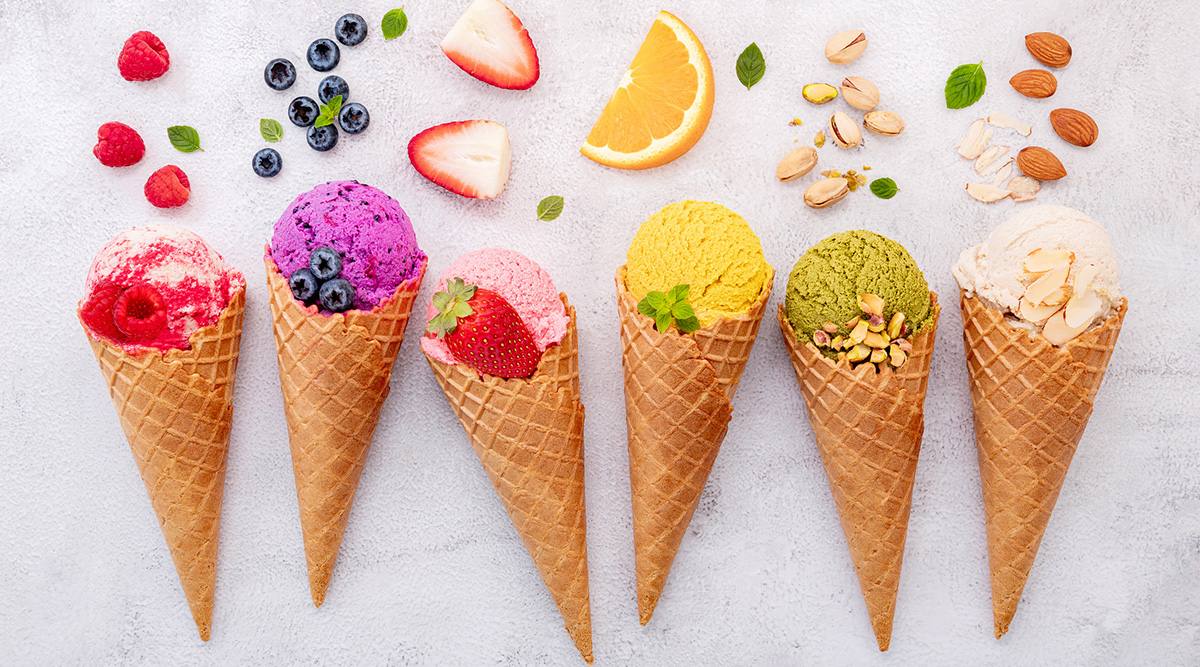 Colorful ice cream cones with fruits and nuts toppings.