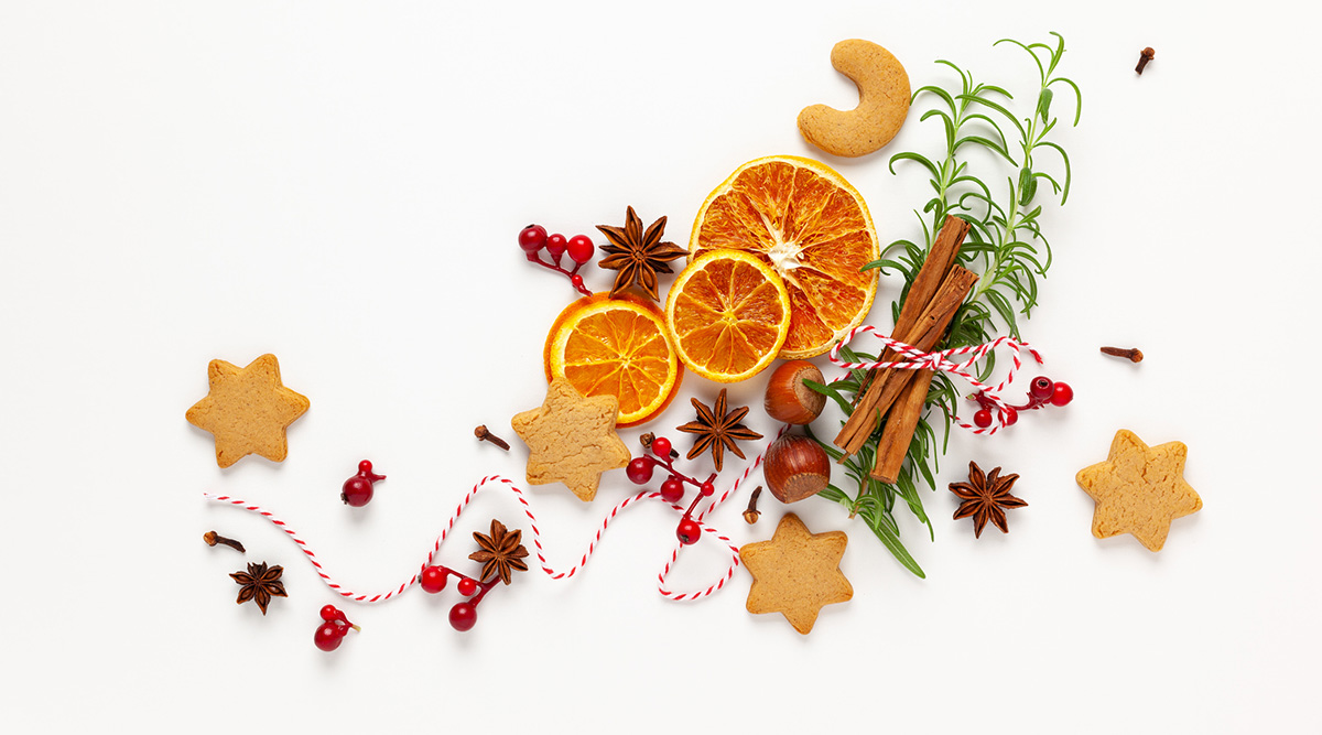 Omnivore Episode 25 holiday cookies, orange slices, cinnamon, chestnuts, red berries, and ribbon